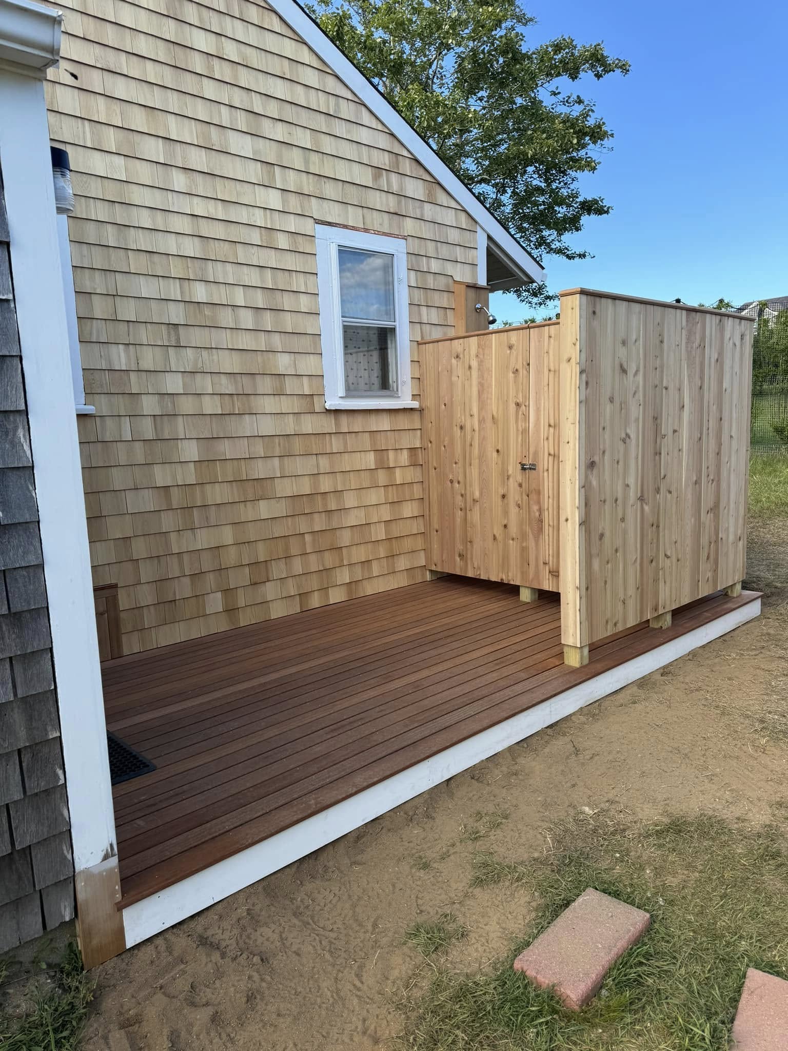 Cedar outdoor shower with composite deck on Nantucket